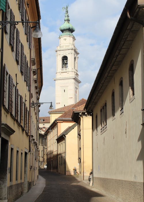 Church Towering over Narrow Alley in Town