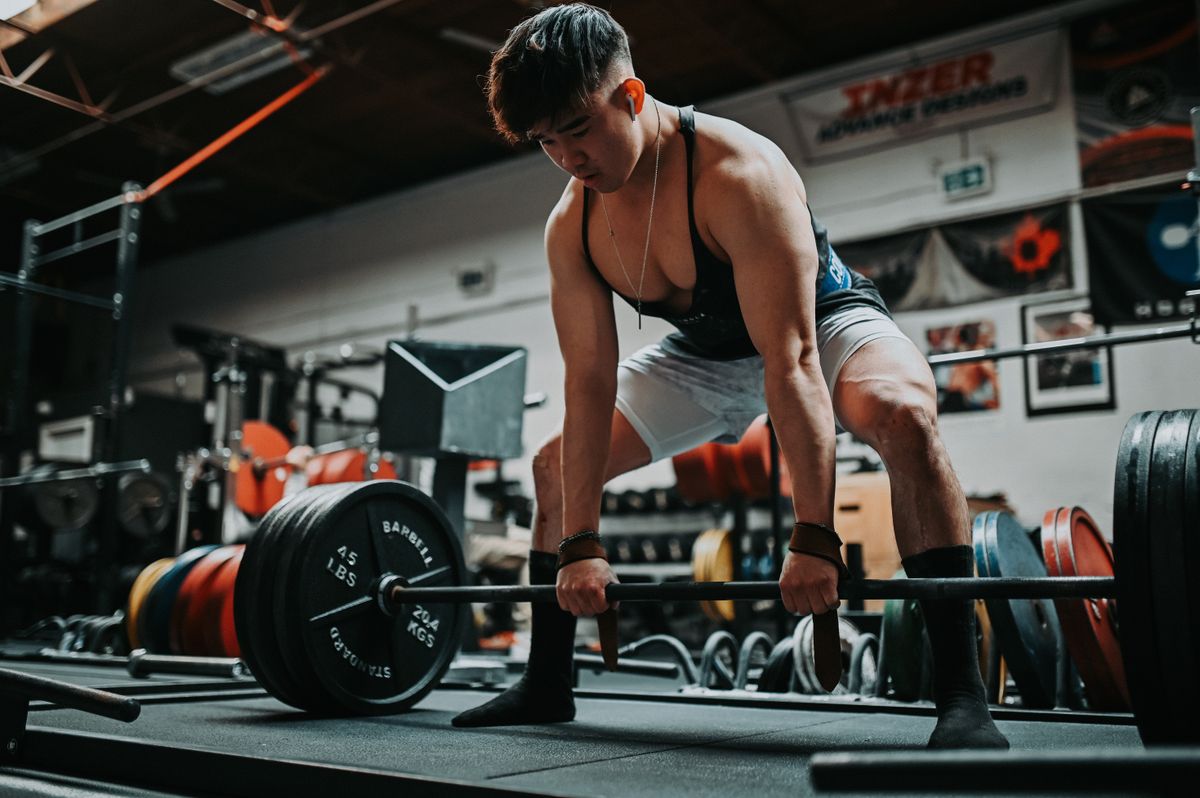 Man performing a deadlift in the gym with proper form