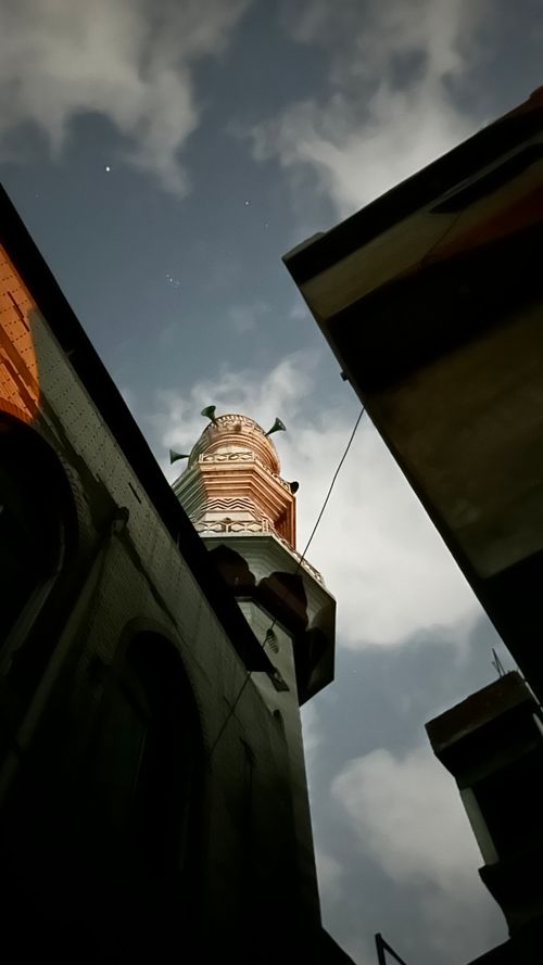 Free Low angle shot of a towering structure silhouetted against a cloudy evening sky. Stock Photo