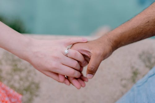 Woman and Man Holding Hands