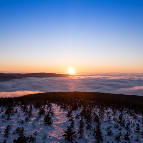 Free Breathtaking aerial view of a snowy forest at sunset in Vysočina Region, Czech Republic. Stock Photo