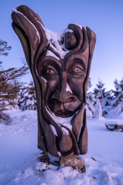 Free A captivating wooden sculpture stands amidst the snowy landscape of Vysočina, Czech Republic. Stock Photo