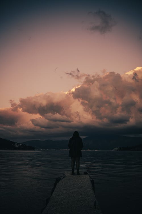 Shot of Person Posing Against Cloudy Sky