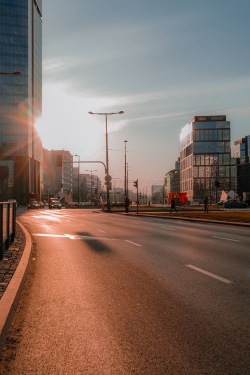 Free A sunlit urban scene featuring modern skyscrapers and city streets, capturing the essence of a bustling cityscape. Stock Photo