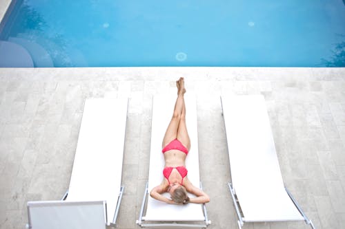 Woman Lying on White Sun Lounger