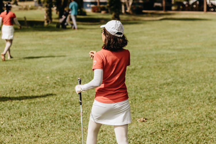 Back View Of Woman Playing Golf