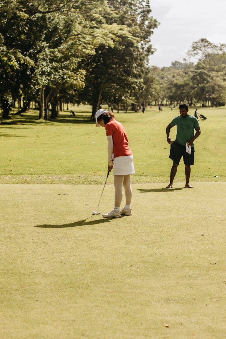 Woman And Man Playing Golf