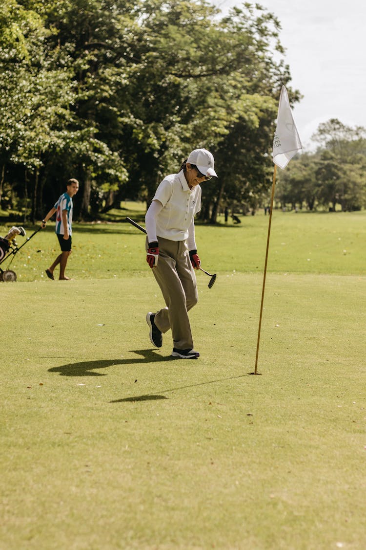 Smiling Woman Playing Golf