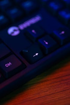 Detailed shot of an arrow key on a computer keyboard with dramatic lighting.