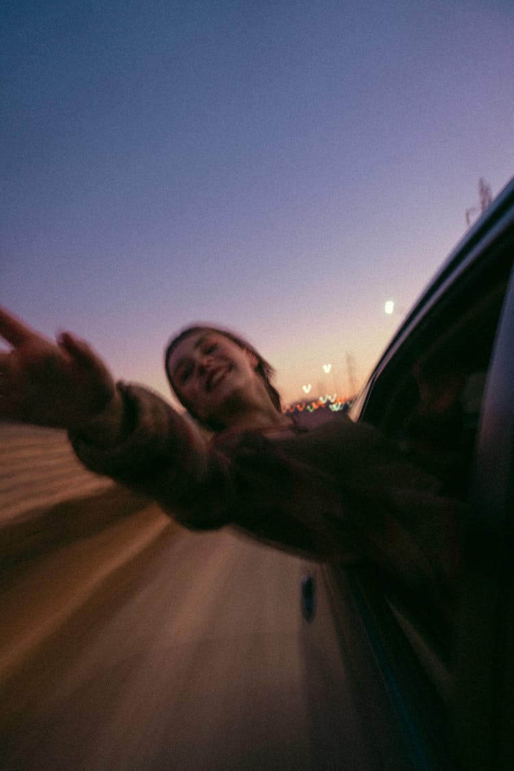 Girl Sticking Her Head Out Of A Moving Car 