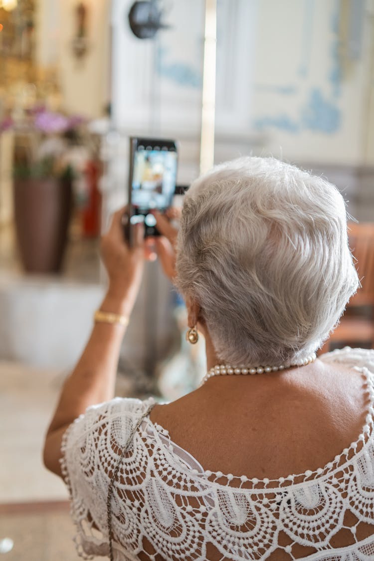 Elderly Woman Taking A Photo With A Smart Phone