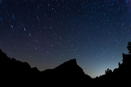 Star trails over mountain ridges, photo by Amel Uzunovic on Pexels