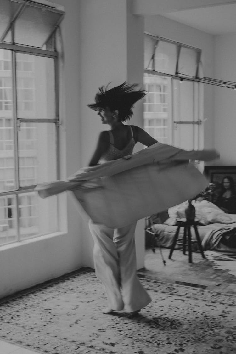 Young Brunette Spinning On A Rug With A Jacket In Hands