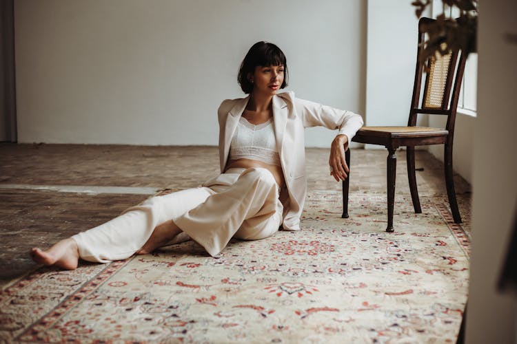 Portrait Of A Young Woman Sitting On A Rug