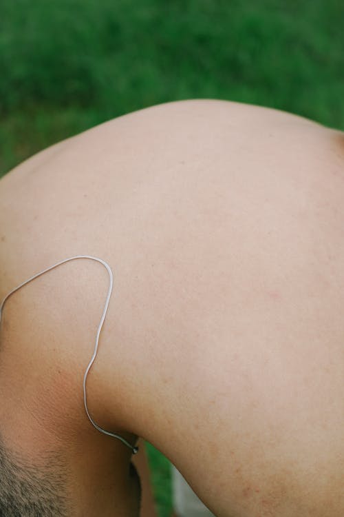 Close-up of a Shirtless Man Bending Forward 