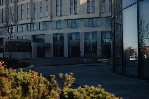 Contemporary office building in Minsk with reflective glass surfaces and urban surroundings.