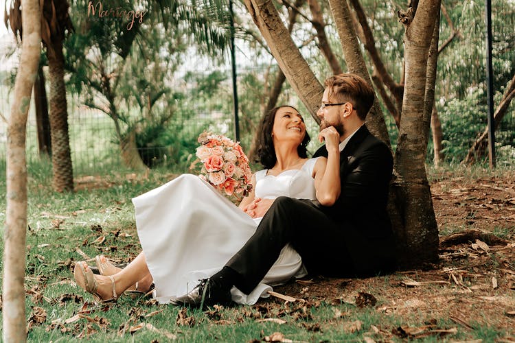 A Couple Sitting Under The Tree