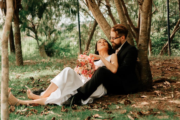 A Couple Sitting Under The Tree