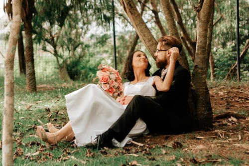 Newlywed Couple Sitting in Park