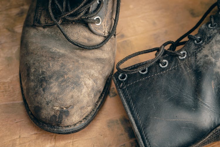 Close-Up Photograph Of Dirty Leather Boots