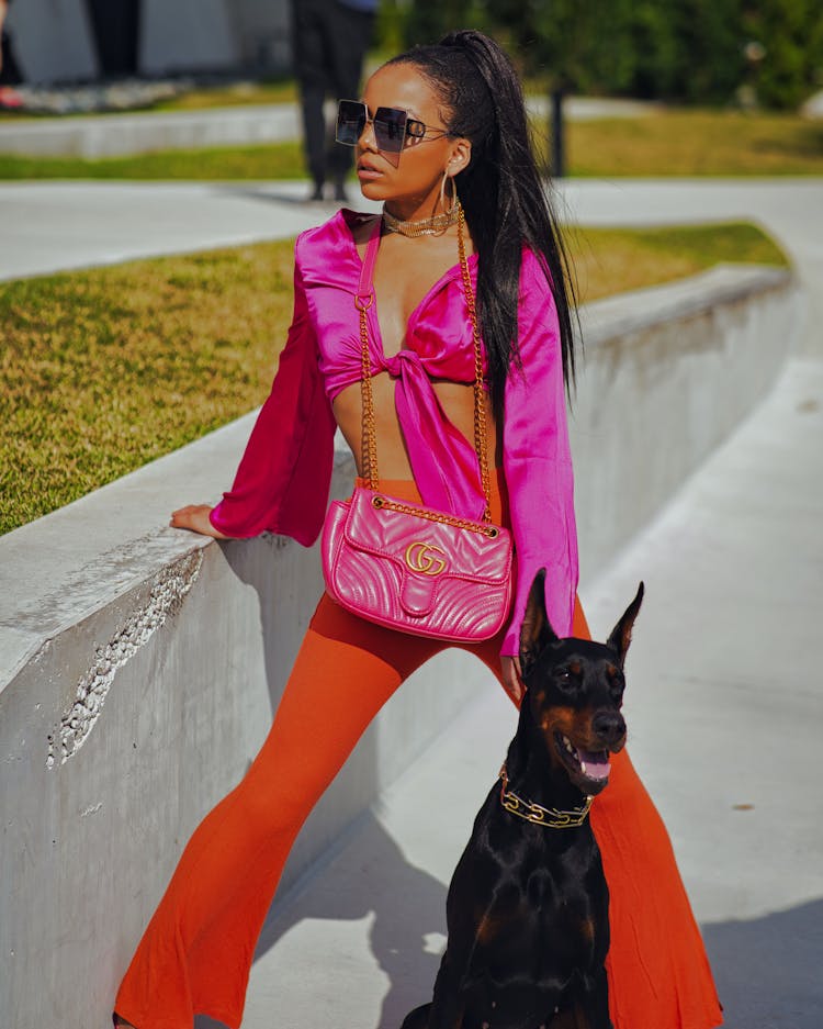 Fashionable Woman Standing Outside With Her Dog 