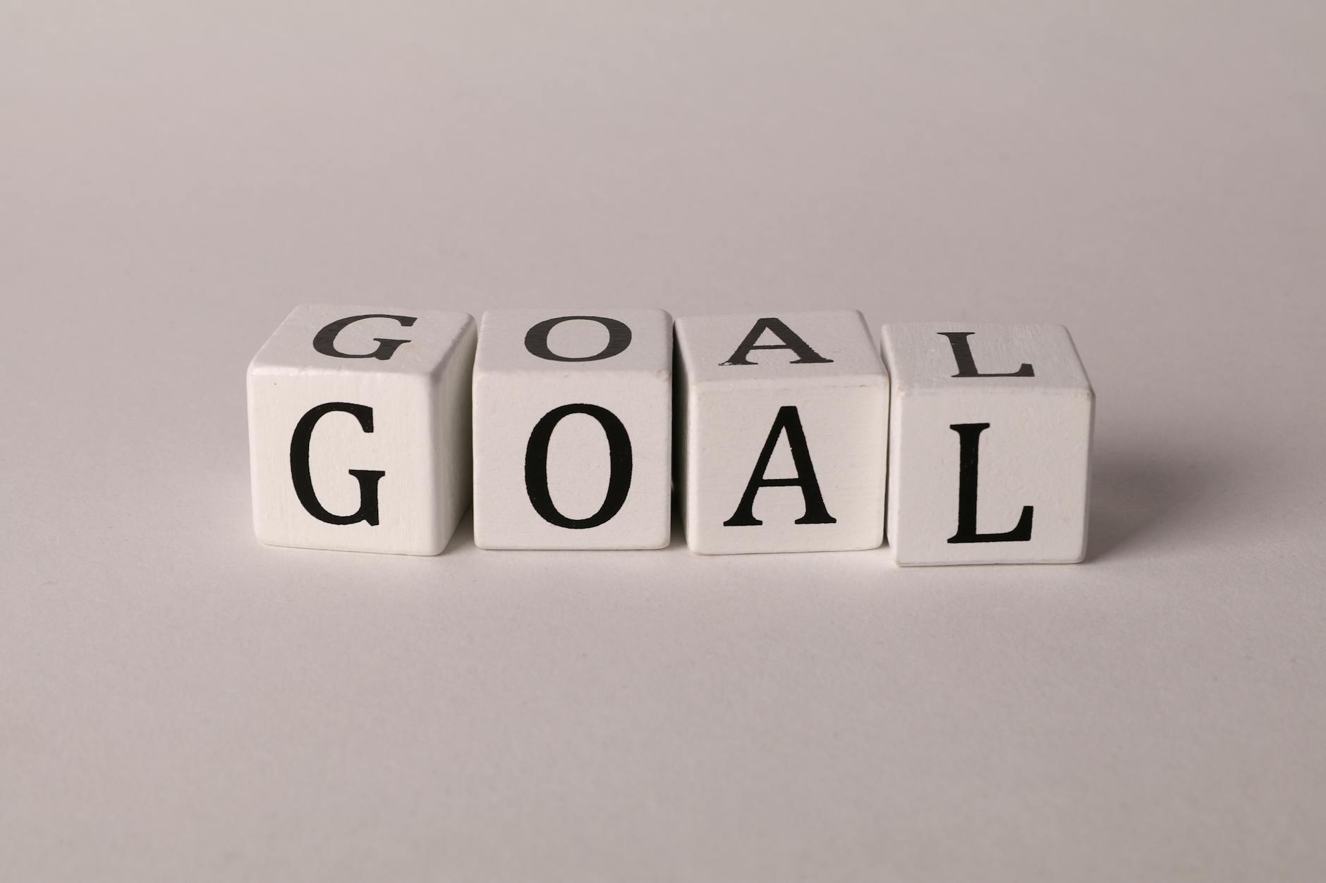 White letter blocks spelling 'Goal' on a neutral backdrop, ideal for business themes.