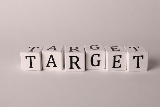 White cubes spelling 'TARGET' on a neutral background, ideal for business or marketing concepts.