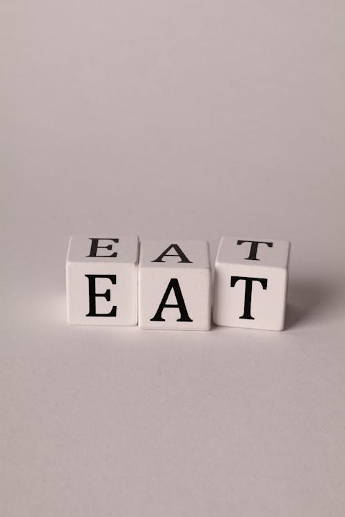 Photo of Cubes with Letters Forming the Word "Eat"