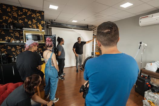 A group of photographers and models collaborating in a modern studio setting.