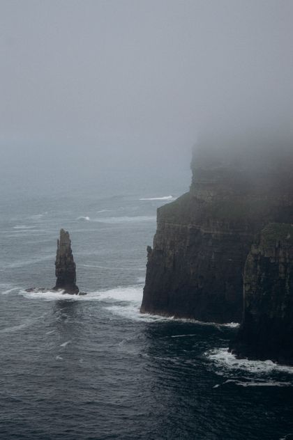 Mist-covered sea cliffs and stacks — photo by Liudmyla Shalimova on Pexels