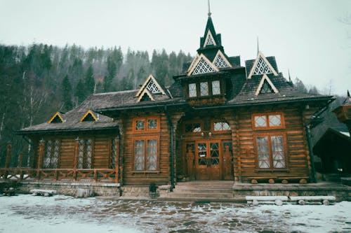 View of a Rustic, Wooden Building on the Background of a Forest in Winter 
