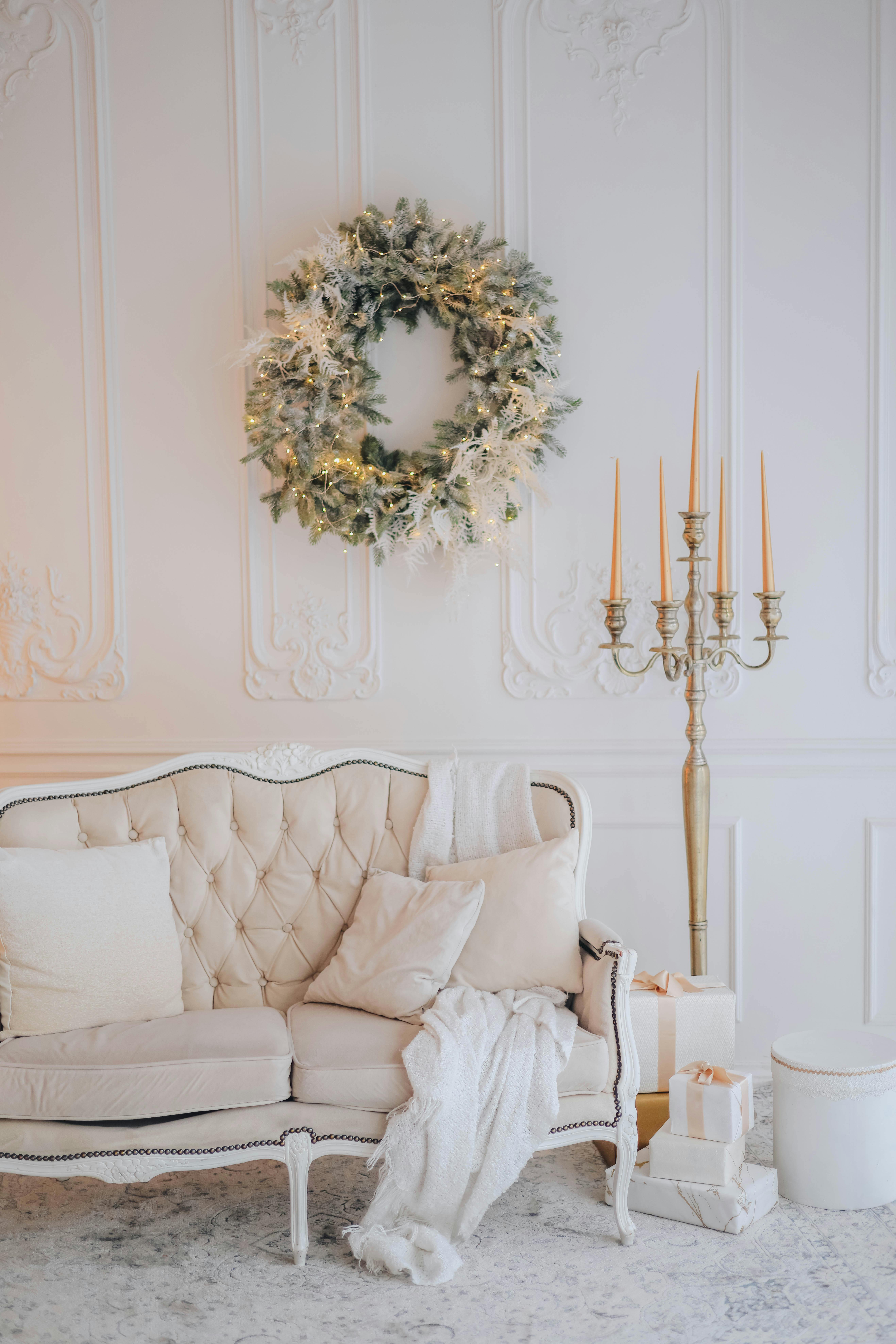 Beautiful living room with Christmas wreath, candles, and festive decor.