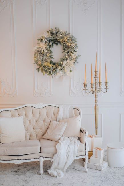 Beautiful living room with Christmas wreath, candles, and festive decor.