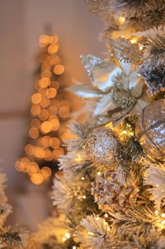 A beautifully decorated Christmas tree with golden ornaments and lights, creating a warm festive atmosphere.
