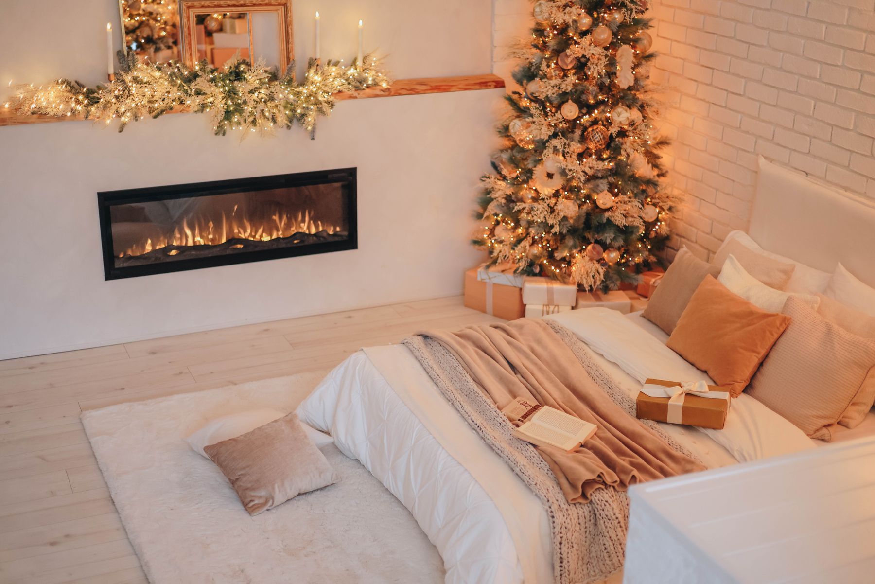 Christmas bedroom with decorated tree and fireplace