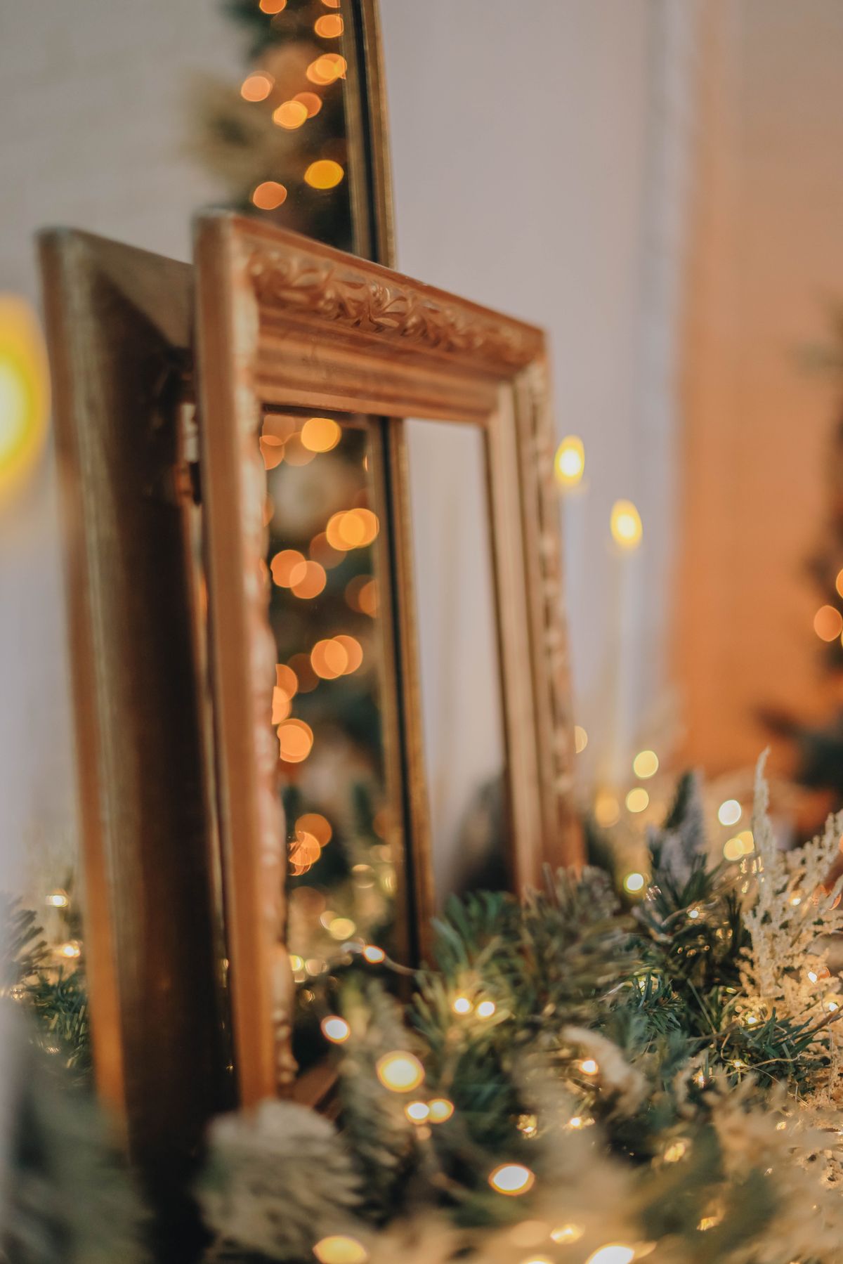 Entryway mirror decorated with a Christmas garland and fairy lights