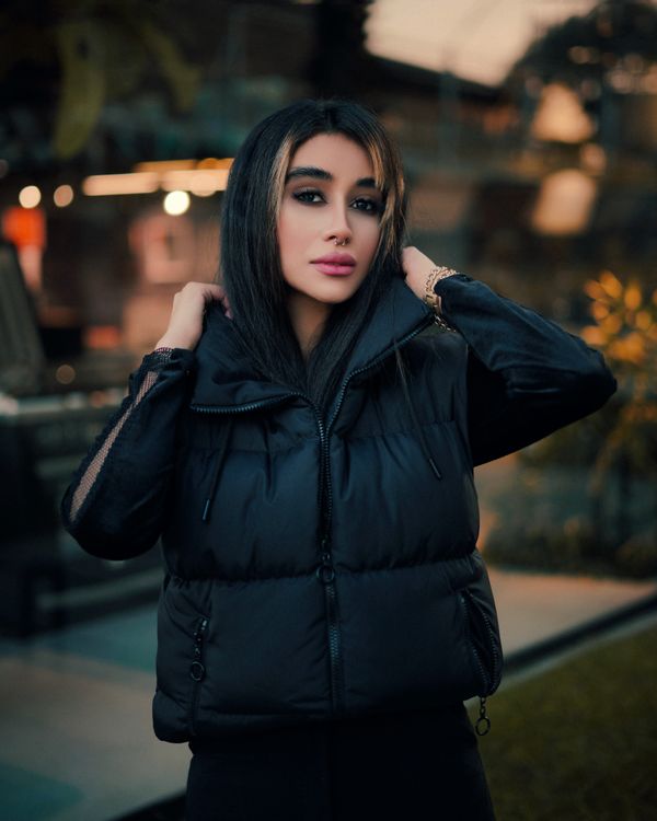 Woman in puffer vest layered outfit