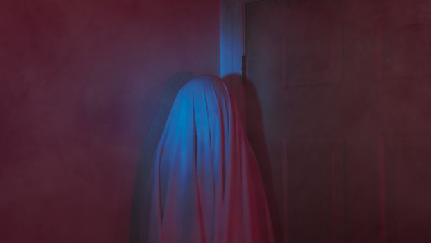 Simulates a ghostly figure in a dark room with a mysterious ambiance.