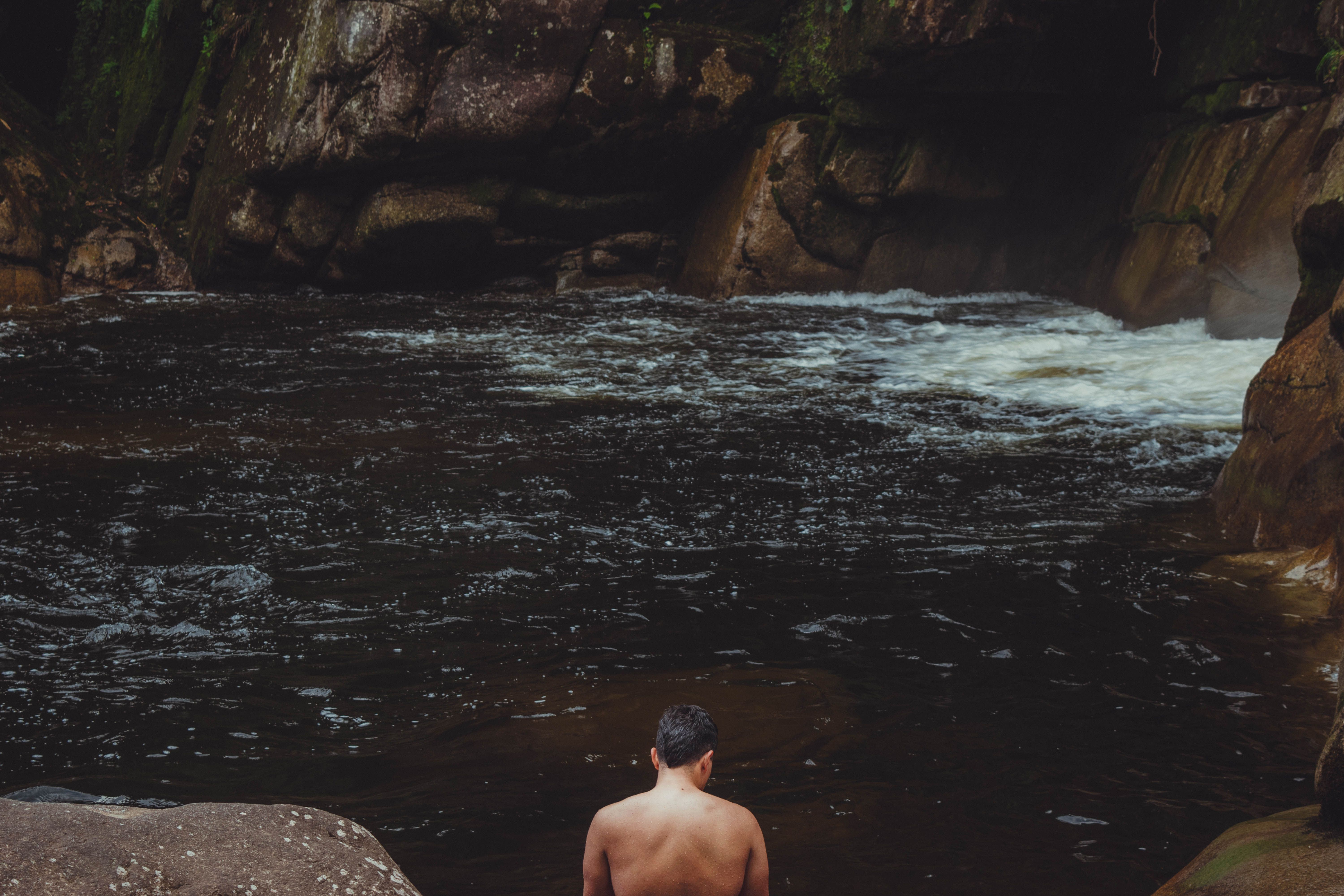 Back View of a Man Standing near a Creek · Free Stock Photo