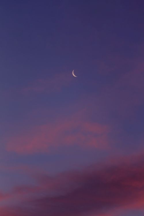 Free A tranquil crescent moon against a colorful purple and pink twilight sky, offering a peaceful visual delight. Stock Photo