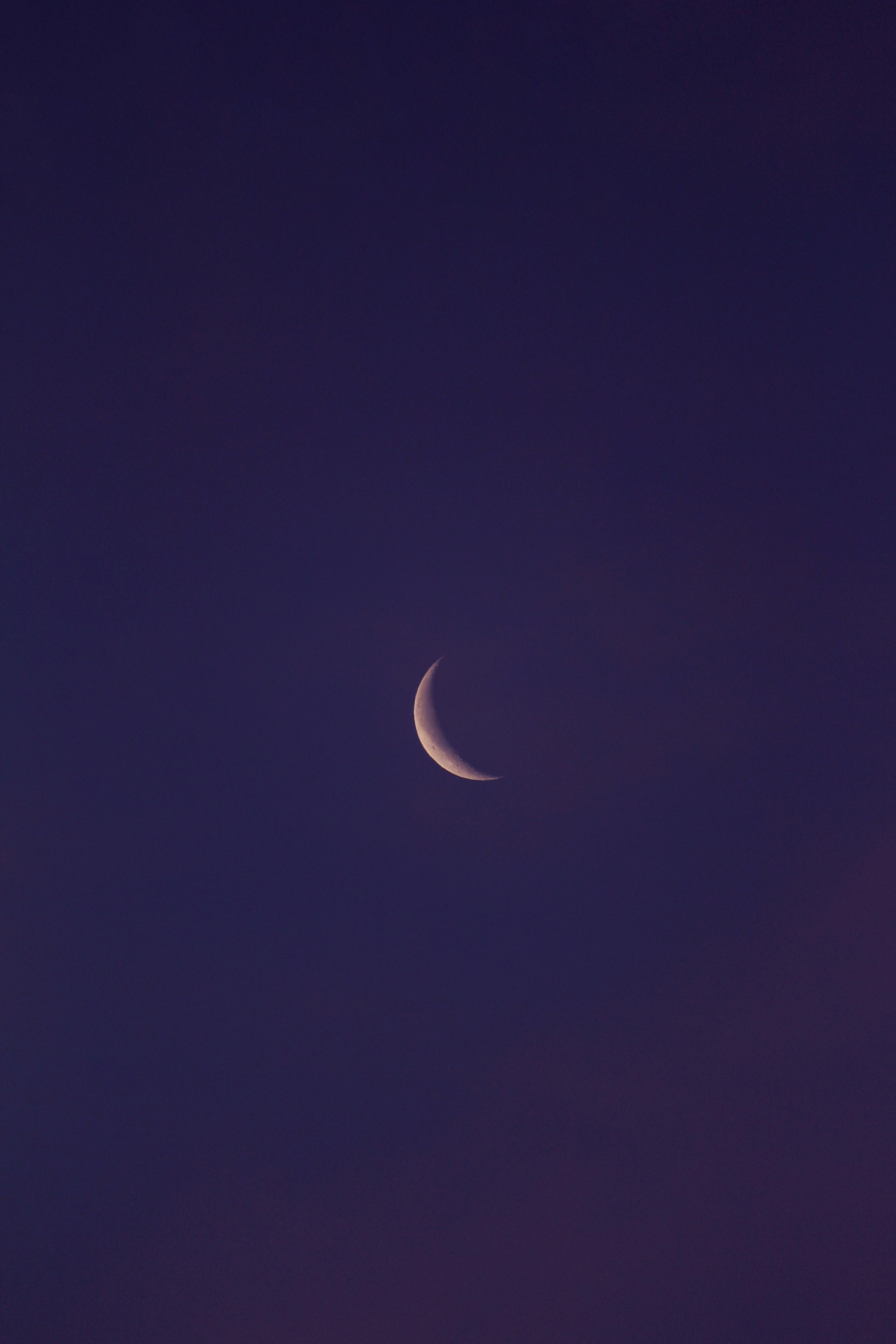 Captivating crescent moon in a clear twilight sky, perfect for serene and dreamy themes.
