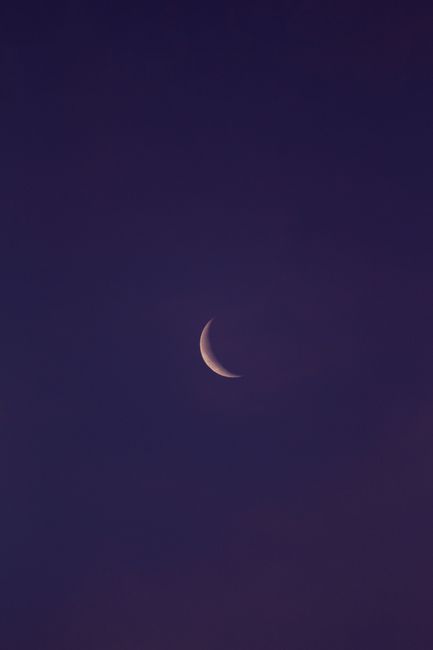 Captivating crescent moon in a clear twilight sky, perfect for serene and dreamy themes.
