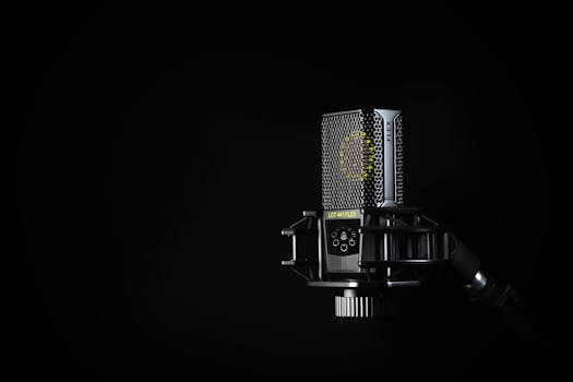 A detailed studio shot of a condenser microphone against a black background, emphasizing modern audio technology.