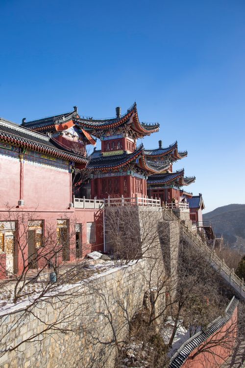 Free Explore the intricate design of a traditional Chinese temple under a clear blue sky. Stock Photo
