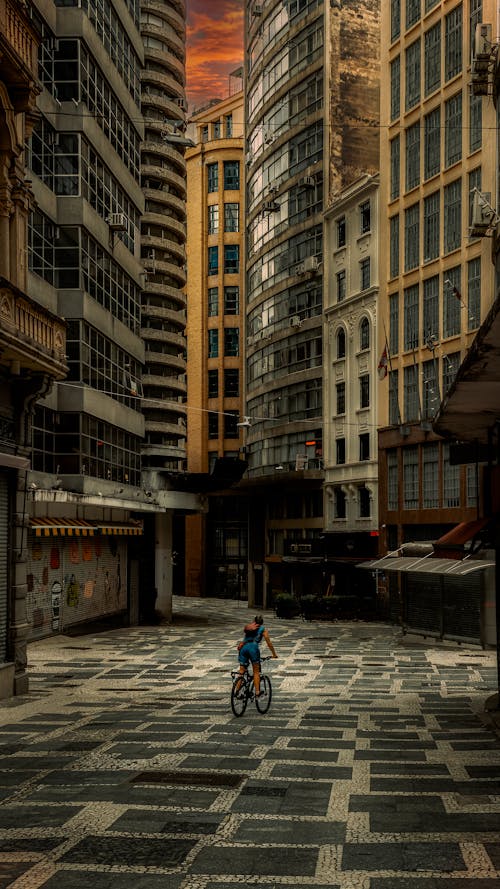 Woman Riding a Bicycle in an Empty City Street 