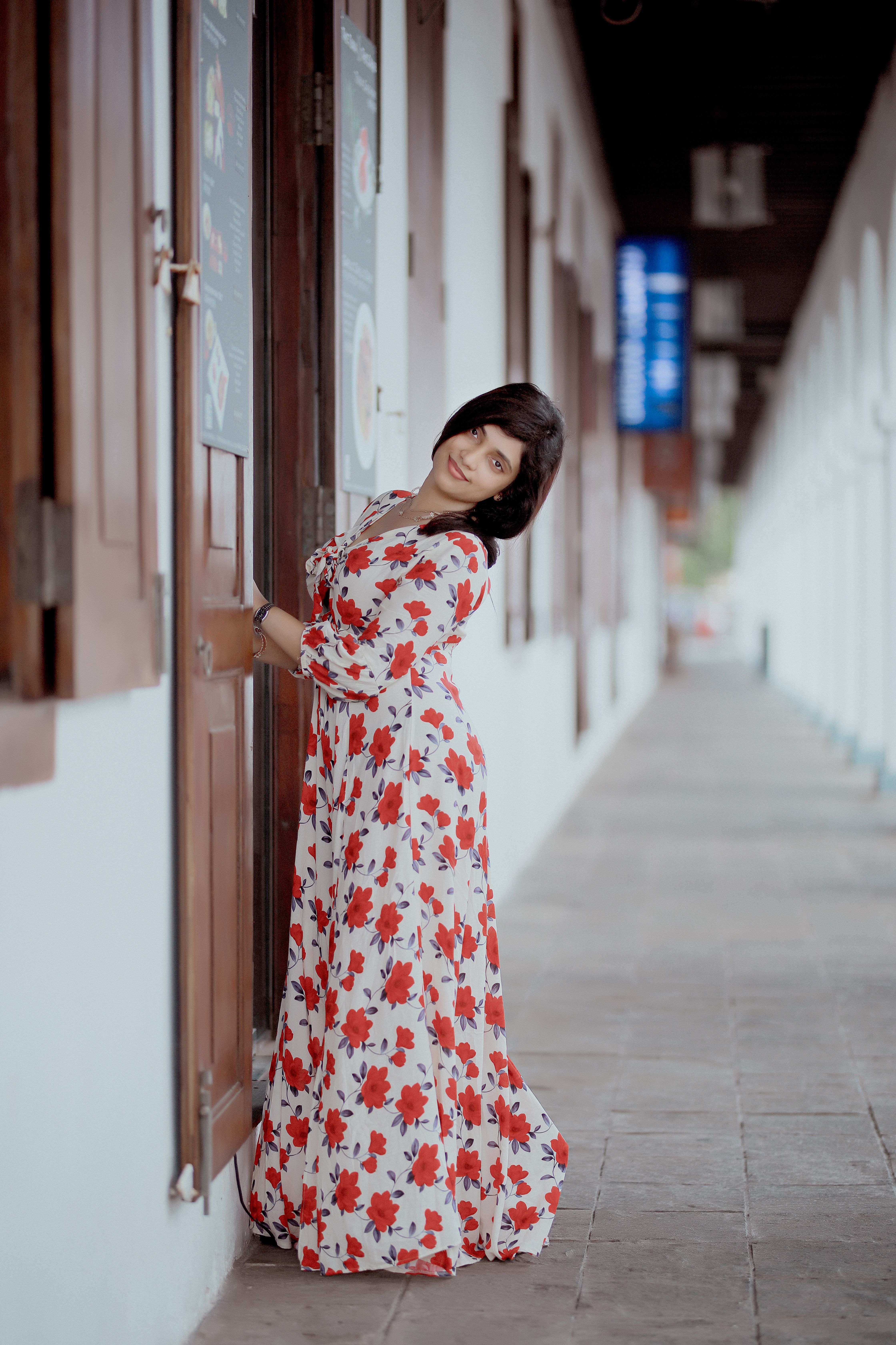Young Woman in a Floral Dress Opening a Door · Free Stock Photo