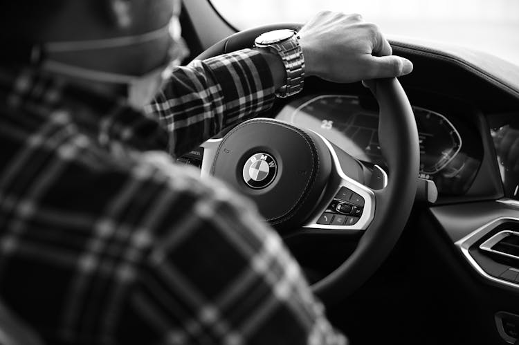 Man Hand On BMW Steering Wheel