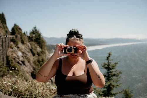 A Woman Taking a Picture With a Film Camera 