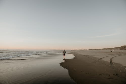 A Man Walking at the Beach 