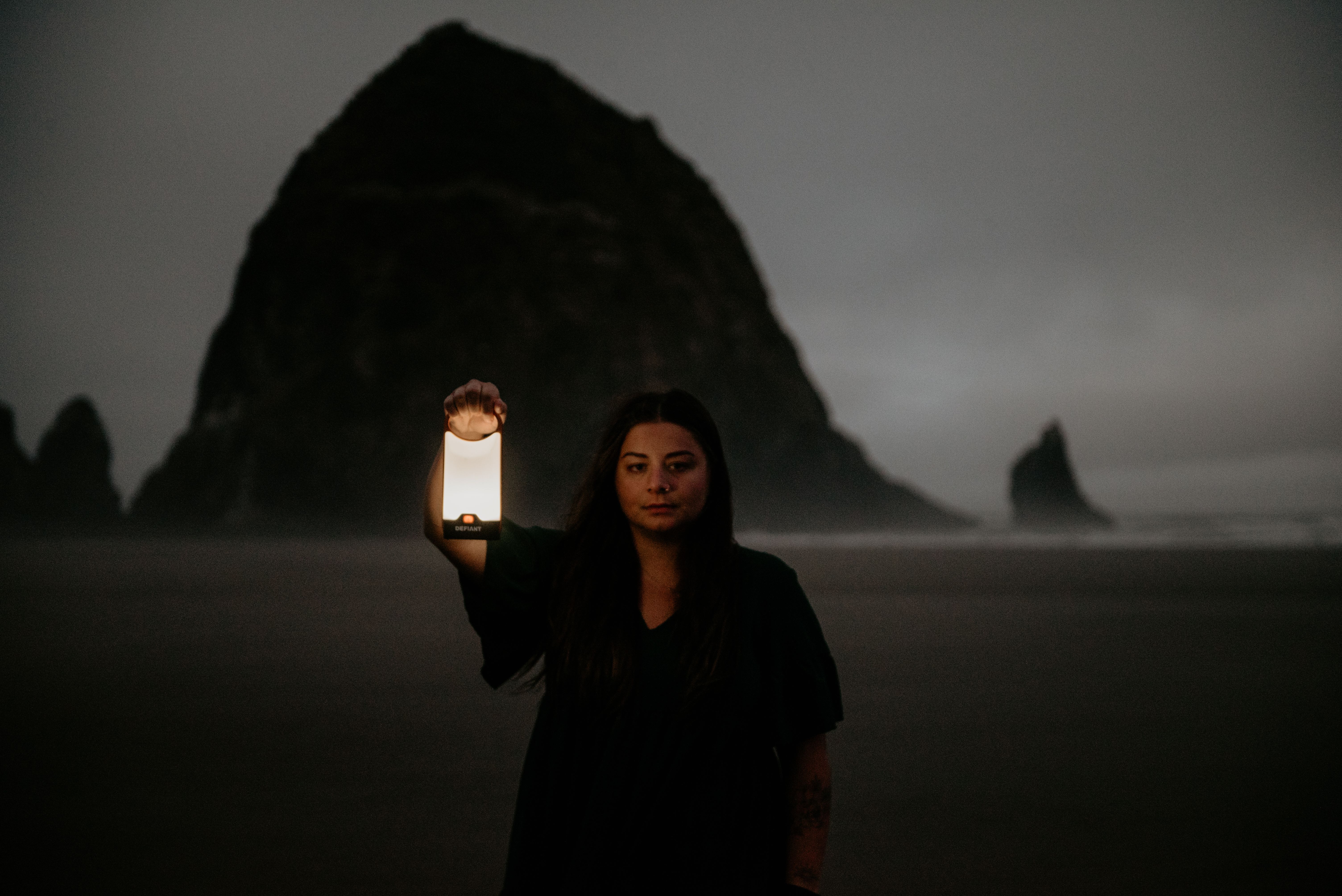 Woman Standing with a Lantern in her Hand on a Beach at Night · Free ...